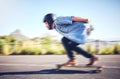 Skateboard, sports man and skating fast on road for fitness, exercise or wellness. Training, freedom and travel