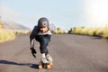 Skateboard, sports and mountain with man in road and travel for speed, freedom and summer break. Motion, adventure and