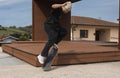 Skateboard trick performance in suburban setting, copy space