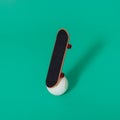 Skateboard on a white golf ball. .Green background Royalty Free Stock Photo