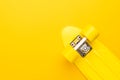 Plastic mini cruiser board on yellow background. bright yellow cruiser skateboard with copy space