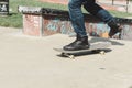 A skateboarder in action doing tricks on ramps at a skate park