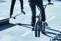 Skateboarder and bicycler. Blue toning Royalty Free Stock Photo