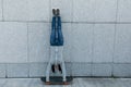 Skateboarder doing a handstand on skateboard against wall Royalty Free Stock Photo