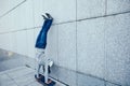 Skateboarder doing a handstand on skateboard against wall Royalty Free Stock Photo