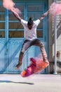 Skateboarder doing kickflip with colorful holi powder Royalty Free Stock Photo