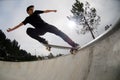 Skateboarder doing a tail slide