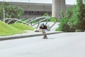 Skateboarder doing a trick at the city`s street in sunny day Royalty Free Stock Photo