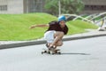 Skateboarder doing a trick at the city`s street in sunny day Royalty Free Stock Photo