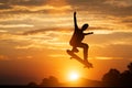 Skateboarder jumping at sunset.