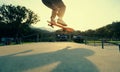 Skateboarder legs practice ollie at skatepark ramp