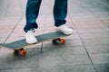 Skateboarder legs riding skateboard on city street Royalty Free Stock Photo
