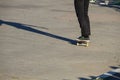 Skateboarder legs riding skateboard at skatepark Royalty Free Stock Photo