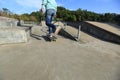 Skateboarder legs riding skateboard at skatepark Royalty Free Stock Photo