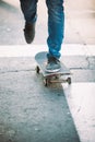Skateboarder legs riding skateboard on the street Royalty Free Stock Photo