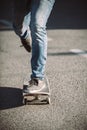 Skateboarder legs riding skateboard on the street Royalty Free Stock Photo