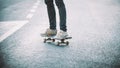 Skateboarder legs riding skateboard on the street Royalty Free Stock Photo