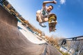 Skateboarder make trick boneless, high jump in mini ramp in skatepark Royalty Free Stock Photo