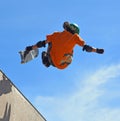 Skateboarder performing grab stunt on Vert Ramp. Royalty Free Stock Photo