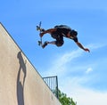 Skateboarder performing grab stunt on Vert Ramp. Royalty Free Stock Photo