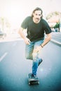 Skateboarder ride a skateboard slope through the city street Royalty Free Stock Photo