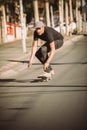 Skateboarder ride a skateboard slope through the city street Royalty Free Stock Photo