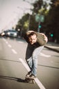 Skateboarder ride a skateboard slope through the city street