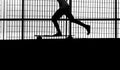 Skateboarder riding a longboard with bare feet photographed in black and white