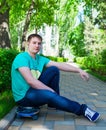 Skateboarder sitting on the skateboard