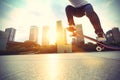 Skateboarder skateboarding at sunrise city