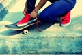 Skateboarder tying shoelace at skate park Royalty Free Stock Photo