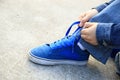 Skateboarder tying shoelace at skate park Royalty Free Stock Photo