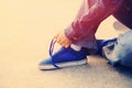 Skateboarder tying shoelace at skate park Royalty Free Stock Photo