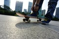 Skateboarder tying shoelace at skate park Royalty Free Stock Photo
