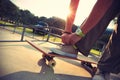 Skateboarder tying shoelace at skate park Royalty Free Stock Photo