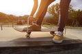 Skateboarder tying shoelaces at skate park Royalty Free Stock Photo