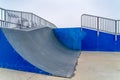 A Skateboarding ramp with railings against sky