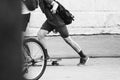 Teen in shorts rides a skateboard. Black and white