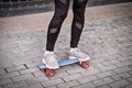 Skateboarding in Urban settings. Teen Girl Is Standing on pennyboard and balancing Royalty Free Stock Photo