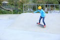 Skateboarding young woman riding on a skateboard