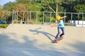 Skateboarding young woman riding on a skateboard