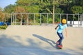 Skateboarding young woman riding on a skateboard