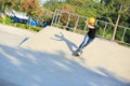 Skateboarding young woman riding on a skateboard