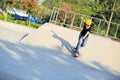 Skateboarding young woman riding on a skateboard