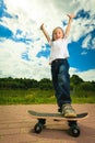 Skater boy child with his skateboard. Outdoor activity. Royalty Free Stock Photo