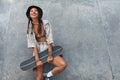 Skater Girl With Skateboard Portrait. Asian Teenager In Casual Outfit Against Concrete Wall At Skatepark. Royalty Free Stock Photo