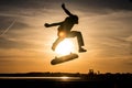 Skater make trick kickflip against the beautiful orange sunset Royalty Free Stock Photo
