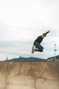 Skater jumping high in the air with a snakeboard in a skatepark with white sky in the background. copyspace Royalty Free Stock Photo