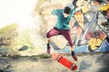 Skater in movement making a trick with his skate at sunset