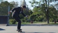 Skater in a suit goes the trick, Heelflip